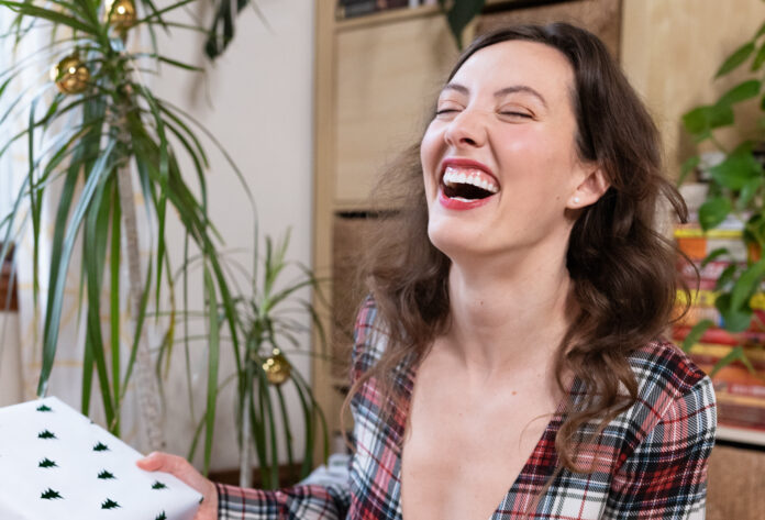 Woman-laughing-with-gift