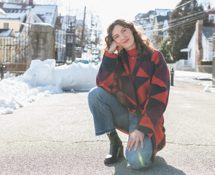 woman-posing-in-colorful-red-and-blue-coat