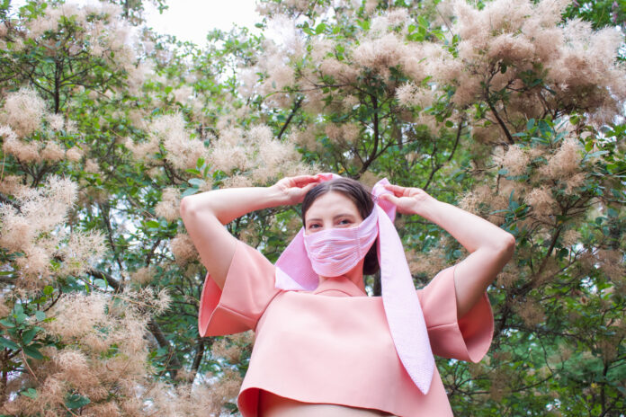 woman-wearing-pink-bow-face-mask-and-pink-top