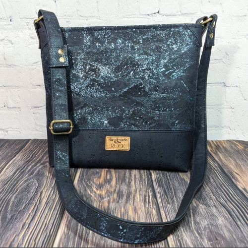 vegan crossbody bag in black with constellation like pattern on material